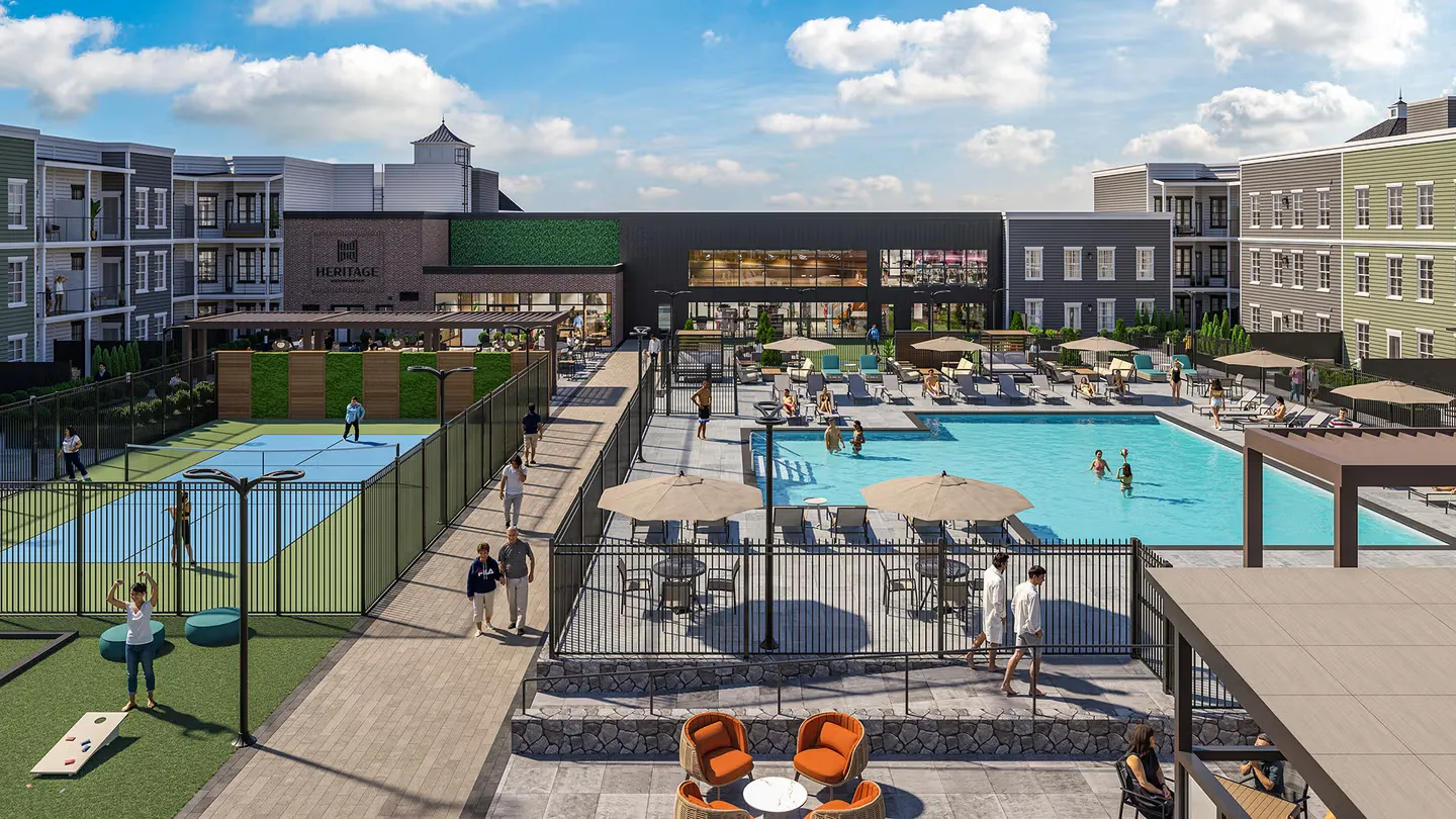 Courtyard with pool, pickleball courts, seating areas, and people enjoying outdoor amenities.