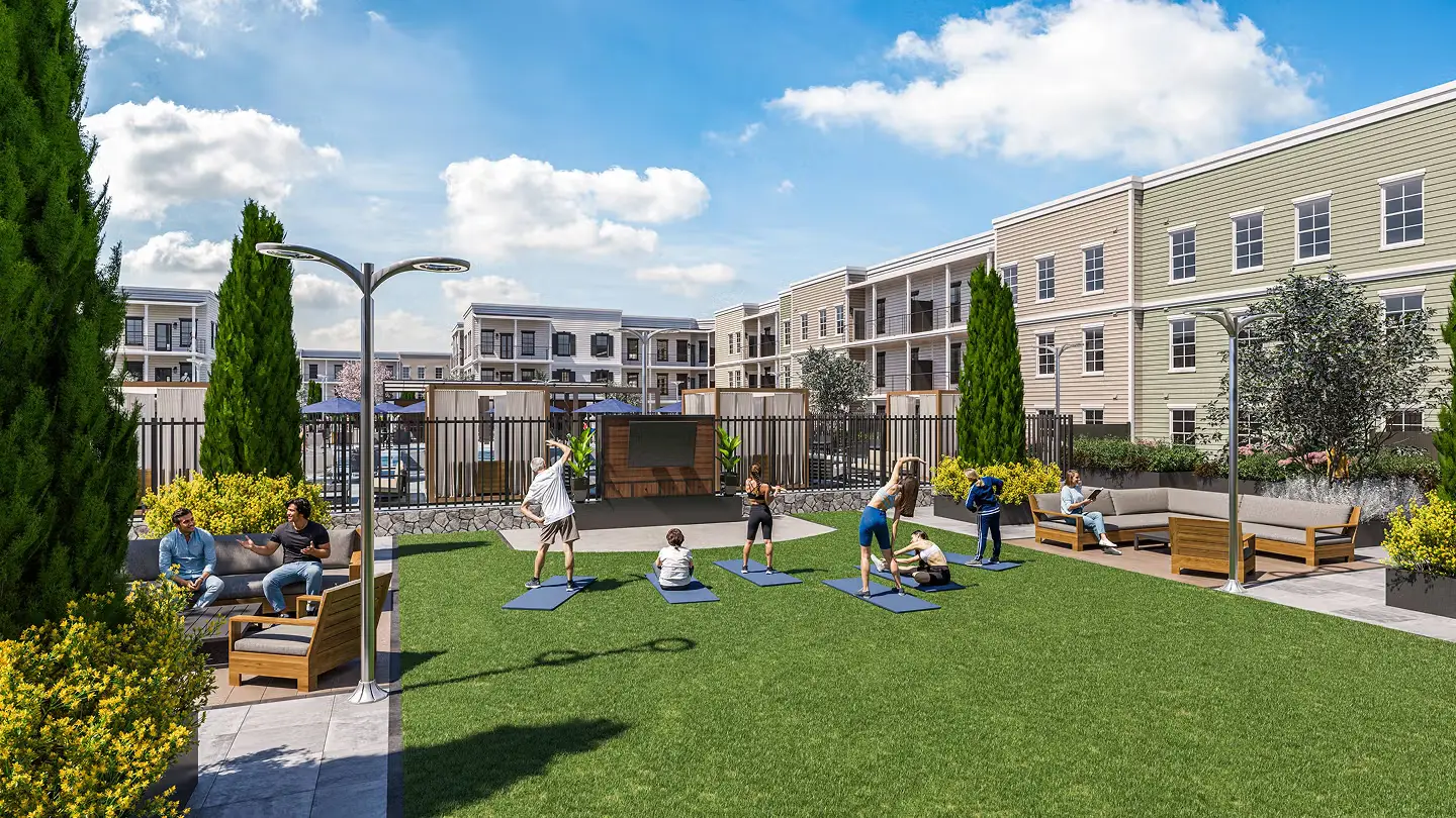 People exercising on yoga mats in a grassy courtyard